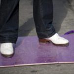 White tap shoes on purple floor